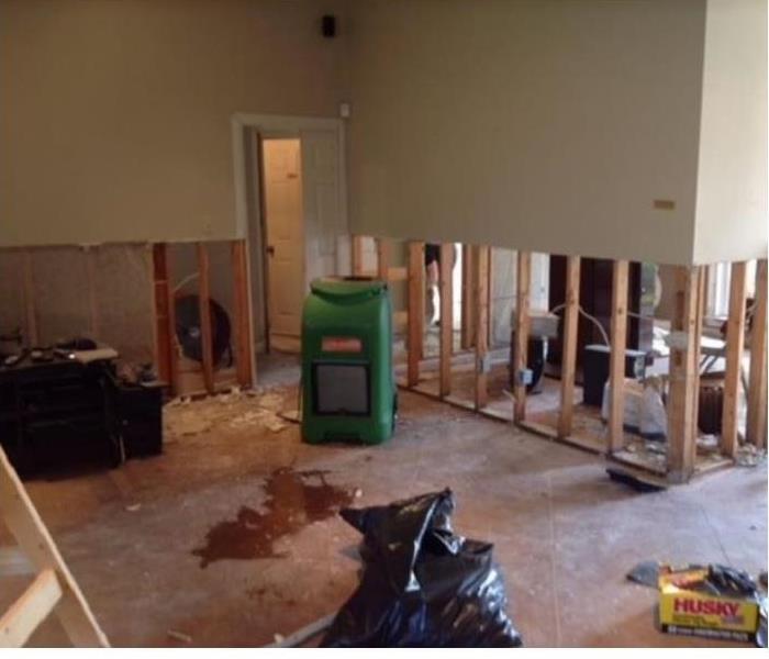 SERVPRO drying equipment on water damaged home. Flood cuts on walls