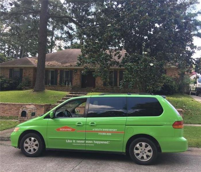 a SERVPRO vehicle parked in front of a house
