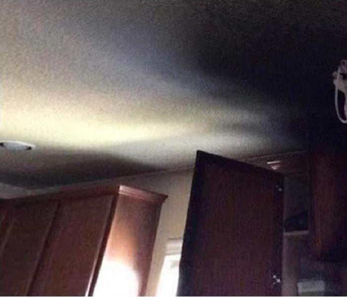 fire damaged cabinet; soot on ceiling