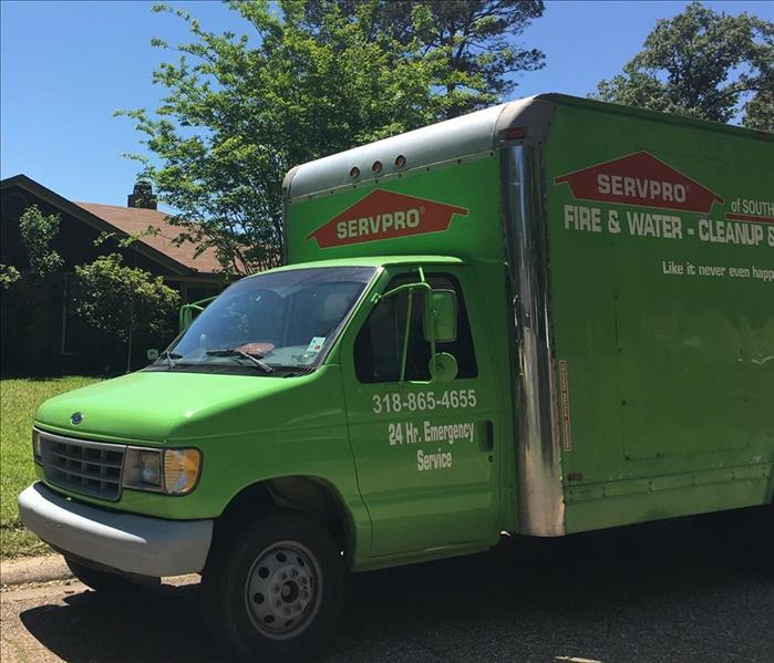 A SERVPRO green box truck parked at a customer's property