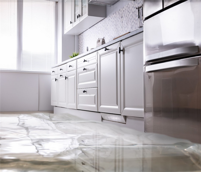 a flooded kitchen with water covering the floor