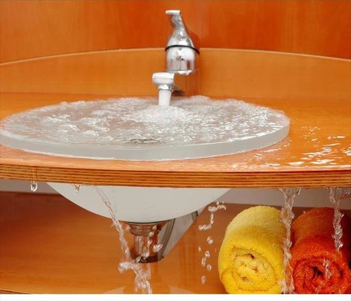 water overflowing from sink, dropping on floor