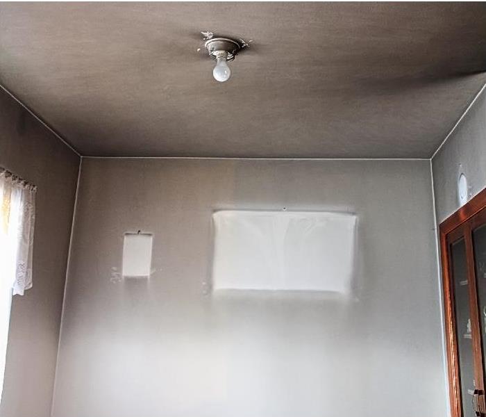 smoke and soot stains on wall and ceiling