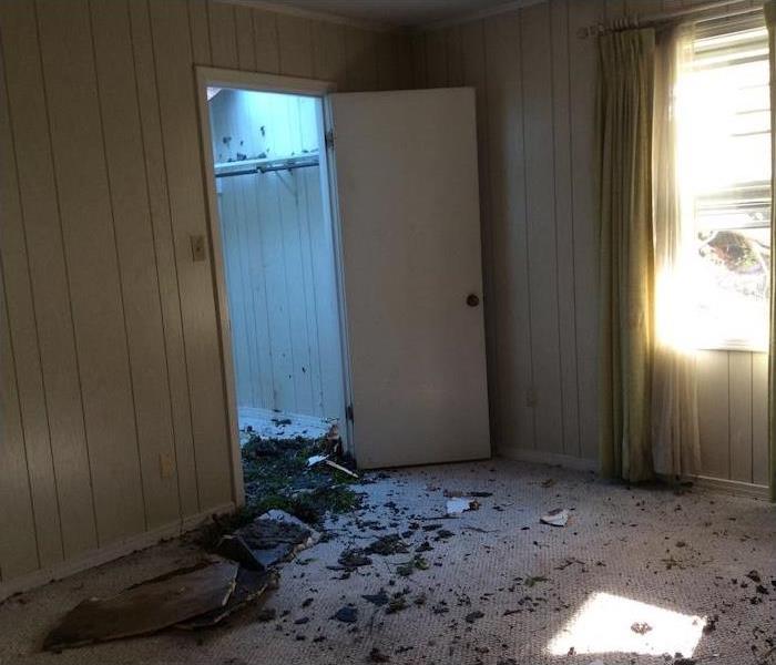 room with fire damage and debris on the floor