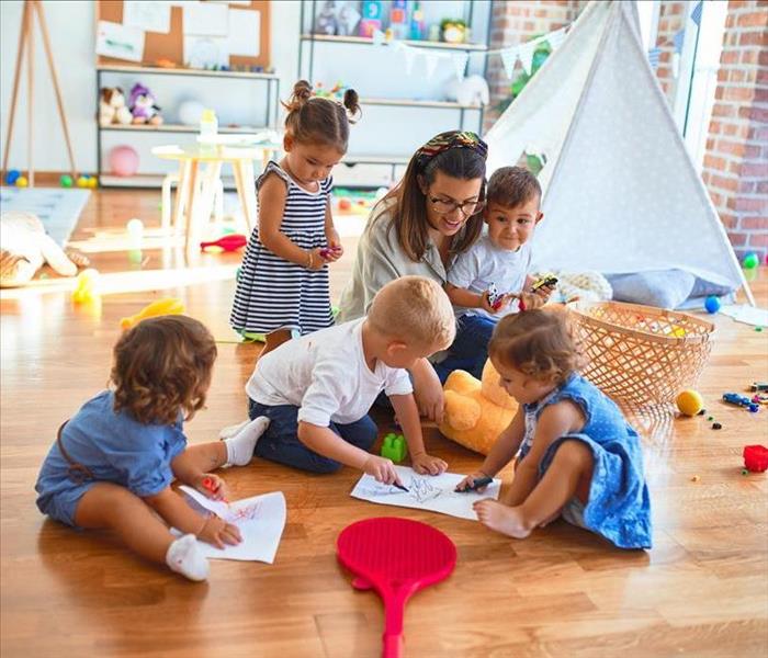 day care with kids on wood floor playing